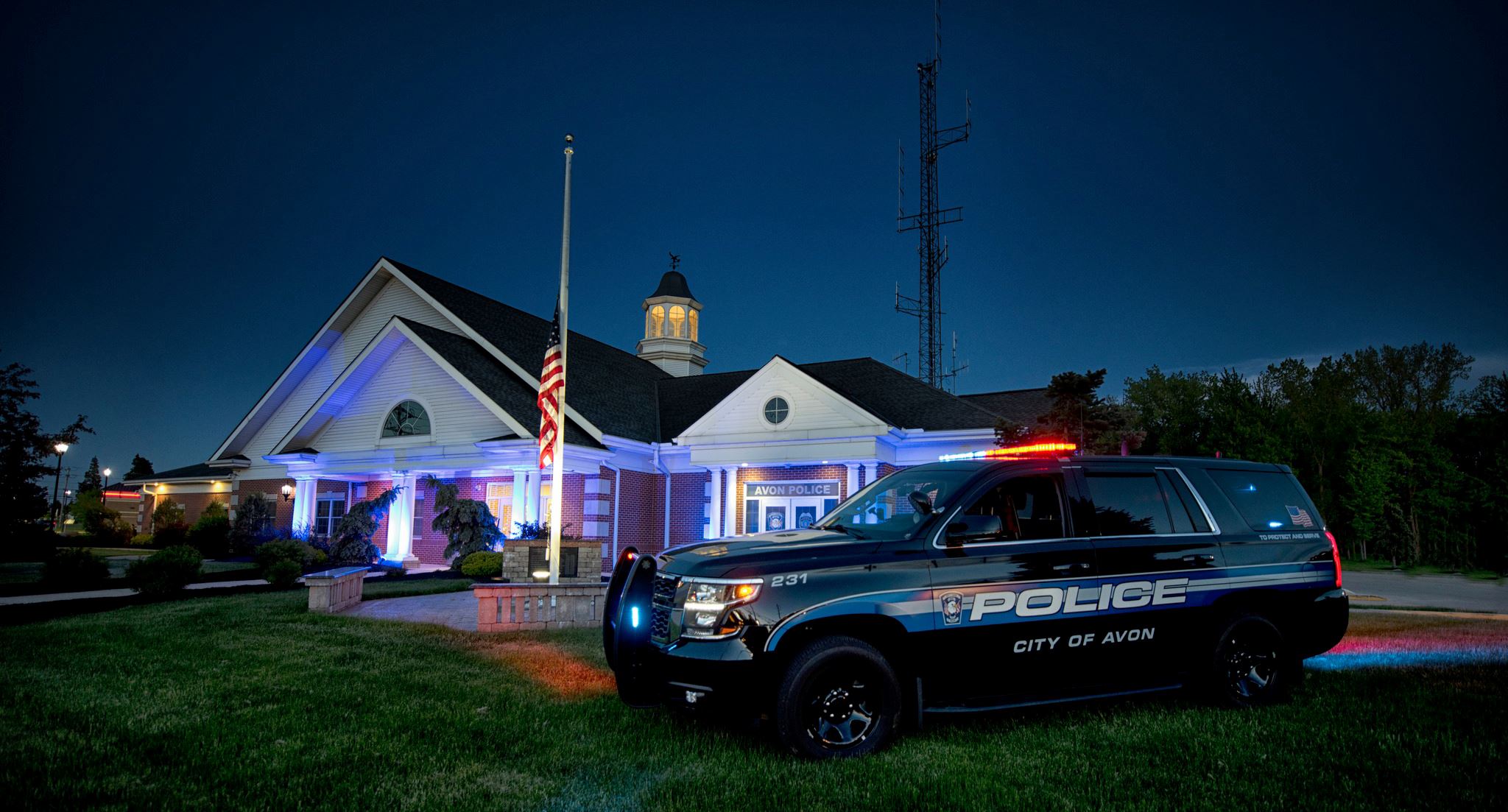 Photo of police cruiser in front of station.